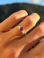 Round ruby ring flanked with diamonds