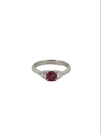 Round ruby ring flanked with diamonds