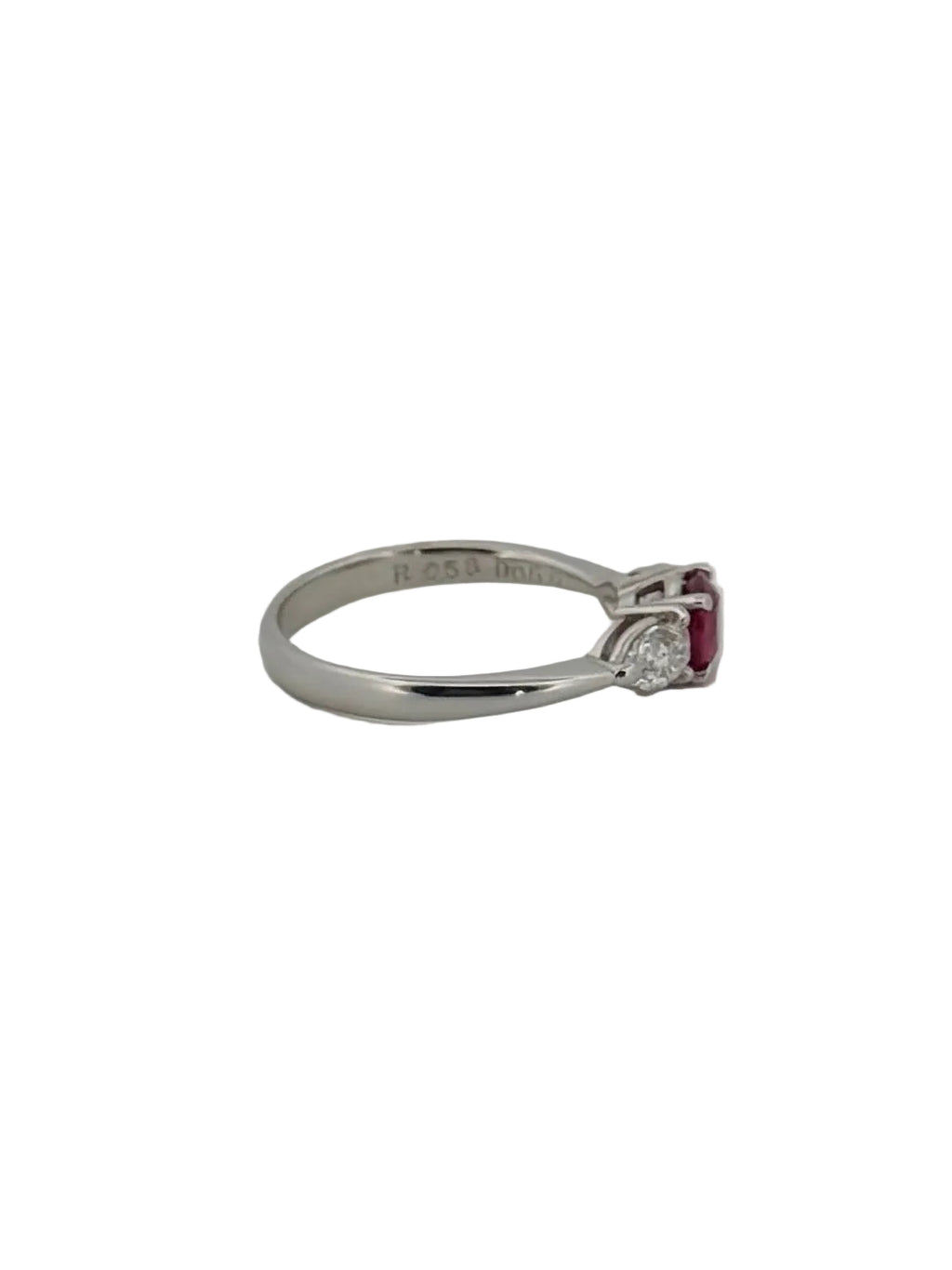 Round ruby ring flanked with diamonds