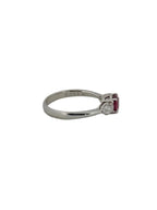 Round ruby ring flanked with diamonds