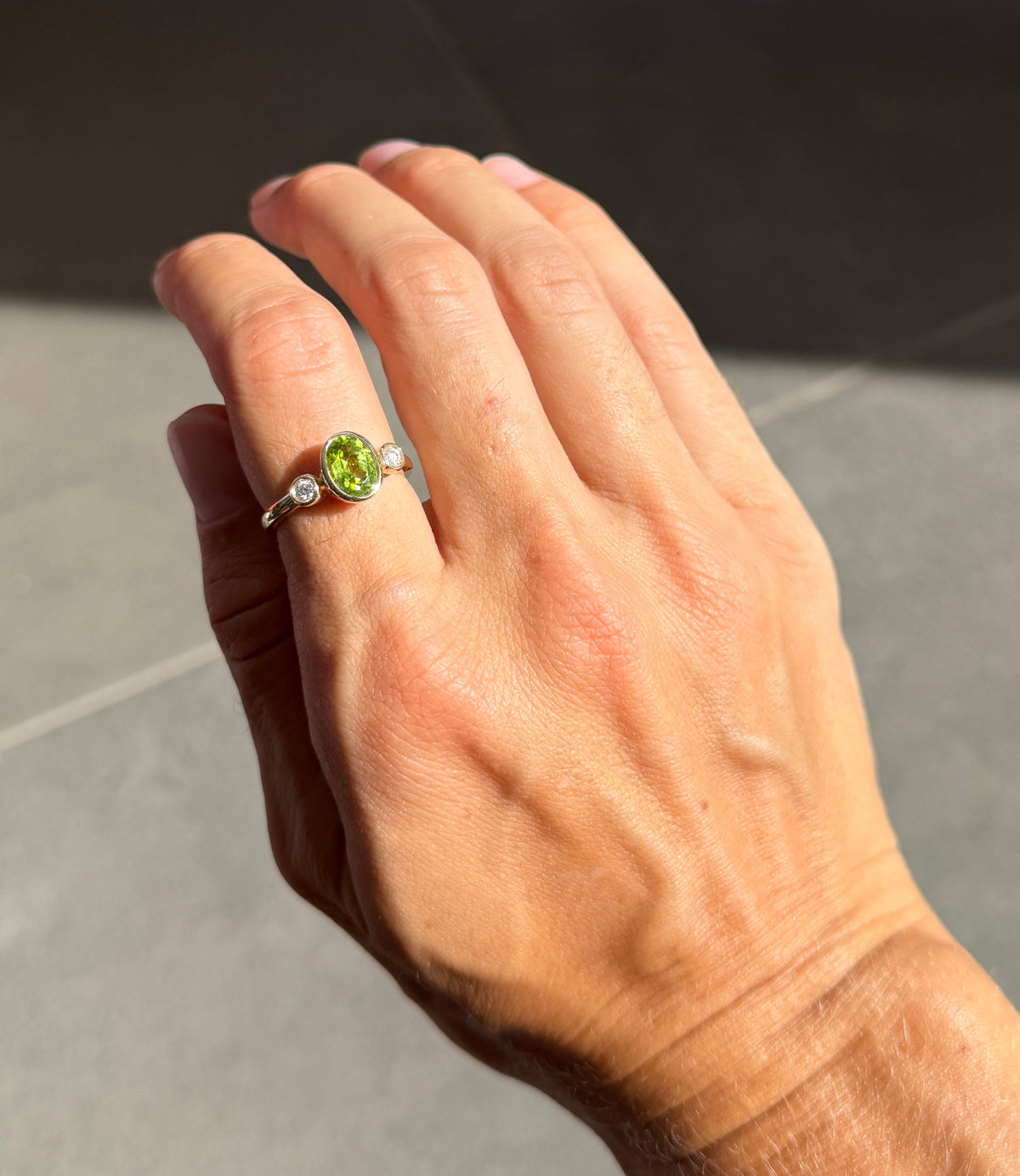 Oval Peridot and Diamond Bezel Ring