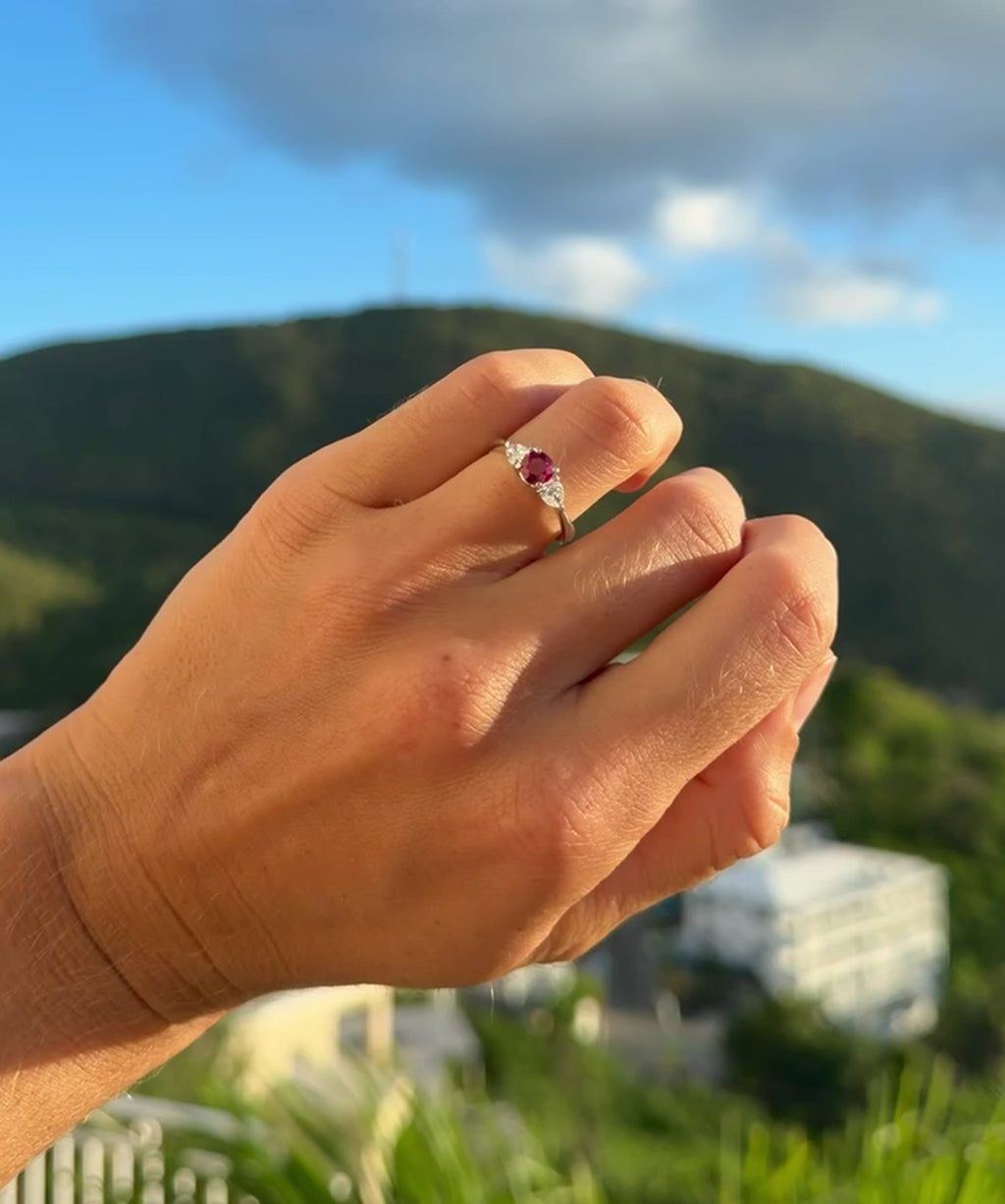 Round ruby ring flanked with diamonds